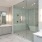 Bath with dual vanities, custom cabinetry, quartz countertops and solid tile flooring 